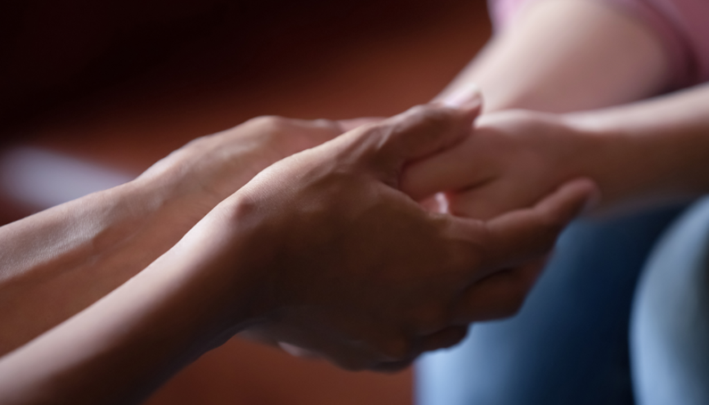 Photo of 2 people holding hands