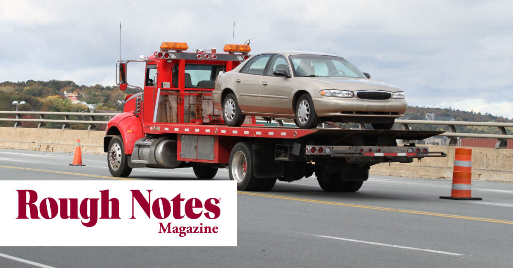 Car on a tow truck bed with the Rough Notes Magazine logo overtop