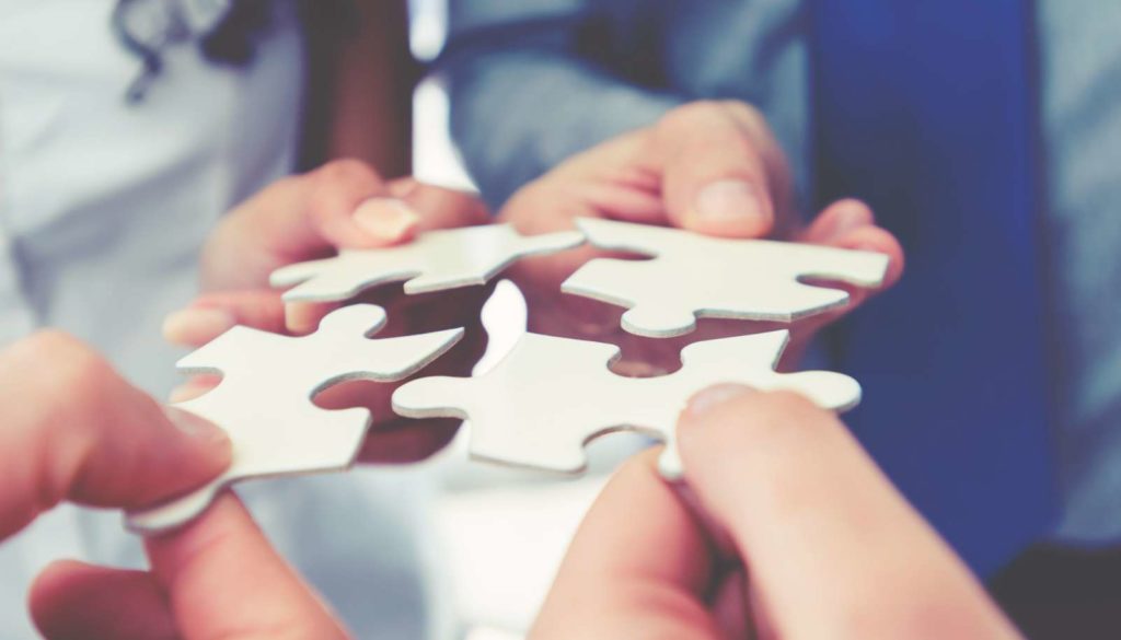 people putting puzzle pieces together