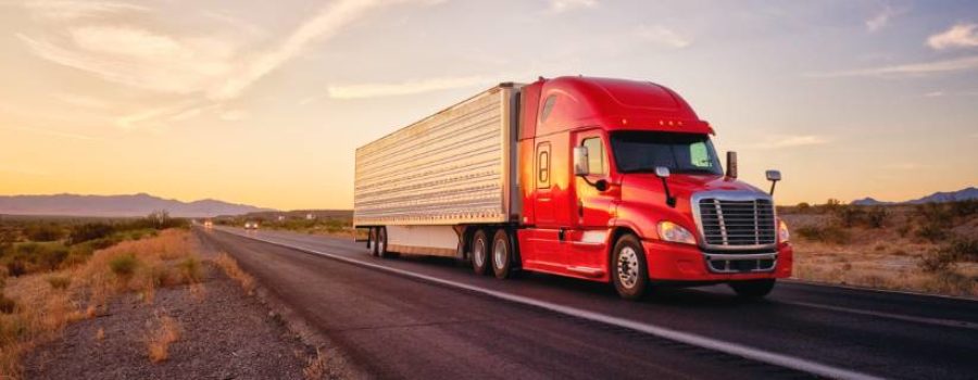 image of a tractor trailer writing down the highway